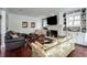 Spacious living room featuring a brick fireplace, hardwood floors, large windows, and cozy seating at 1923 Rugby Ave, Atlanta, GA 30337