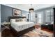A luxurious bedroom with a large bed, wood floors, and a chandelier at 1923 Rugby Ave, Atlanta, GA 30337