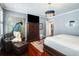 Cozy bedroom with a sitting area, a large dresser, and a stylish chandelier at 1923 Rugby Ave, Atlanta, GA 30337