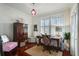Well-lit home office with dark wood furniture, a patterned rug, and shuttered windows at 1923 Rugby Ave, Atlanta, GA 30337