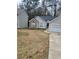 Single-story home with stone accents, gray vinyl siding, two-car garage, and mature trees at 2071 Boone Pl, Snellville, GA 30078