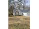 Cozy one-story house with stone details, gray siding, and lush trees in a quiet neighborhood at 2071 Boone Pl, Snellville, GA 30078