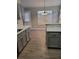 Bright kitchen and dining area with gray cabinets, white countertops, and a modern light fixture at 2071 Boone Pl, Snellville, GA 30078