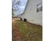 View of side yard with home's siding, AC unit, and landscaping at 2071 Boone Pl, Snellville, GA 30078