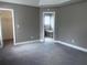 Spacious bedroom with neutral carpet and access to bathroom and walk-in closet at 4415 Yates Rd, Atlanta, GA 30337