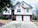 Charming two-story home featuring a two-car garage, landscaped yard, and a welcoming front entrance at 4415 Yates Rd, Atlanta, GA 30337