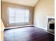 Cozy living room featuring a fireplace, hardwood floors, and a large window for natural light at 4415 Yates Rd, Atlanta, GA 30337