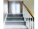 Carpeted staircase leading to the upper level with natural lighting from the front door at 4415 Yates Rd, Atlanta, GA 30337