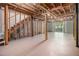 Unfinished basement with exposed beams and walkout to the backyard at 6437 Stone Way, Morrow, GA 30260