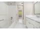 Bright bathroom features a tub, a single sink vanity, white tile flooring and crisp, white walls at 6437 Stone Way, Morrow, GA 30260