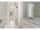 Bright bathroom features a tub, a single sink vanity, white tile flooring and crisp, white walls at 6437 Stone Way, Morrow, GA 30260