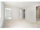 Light-filled bedroom featuring neutral carpet, large closet with mirrored doors, light gray walls, and a big window at 6437 Stone Way, Morrow, GA 30260