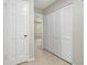 Hallway features neutral carpet, light gray walls, and a large closet with white louvered doors at 6437 Stone Way, Morrow, GA 30260