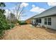 Scenic backyard view with a patio, seasonal landscaping and mature trees surrounding the property at 505 Appalachian Woods Dr, Canton, GA 30114
