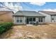 Back exterior of house and patio with lawn furniture and view of neighbors and trees at 505 Appalachian Woods Dr, Canton, GA 30114