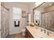 Bright bathroom with a large mirror, sink, toilet, cabinet, window and decorative shower curtain at 505 Appalachian Woods Dr, Canton, GA 30114