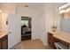 Bright bathroom with double vanity, tile flooring, and door leading to bedroom at 505 Appalachian Woods Dr, Canton, GA 30114