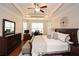 Bedroom featuring tray ceiling, ceiling fan, and hardwood floors at 505 Appalachian Woods Dr, Canton, GA 30114