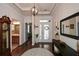 Elegant foyer with hardwood floors, decorative mirror, and an ornate front door at 505 Appalachian Woods Dr, Canton, GA 30114