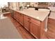 Close-up of the kitchen island featuring wooden cabinets, granite countertops and stainless steel dishwasher at 505 Appalachian Woods Dr, Canton, GA 30114
