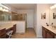 A well-lit main bathroom with double vanity, a glass enclosed shower and tile floors at 505 Appalachian Woods Dr, Canton, GA 30114