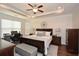 Spacious main bedroom with a trey ceiling, a large bed, and a cozy sitting area with a desk for working at 505 Appalachian Woods Dr, Canton, GA 30114