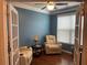 Stylish office space featuring French doors, hardwood floors, and comfortable seating for a relaxed work environment at 505 Appalachian Woods Dr, Canton, GA 30114