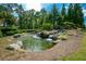 Pond and waterfall in gated community with a sign reading 
