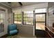 Relaxing sunroom with multiple windows, a comfortable chair, and an outdoor view at 505 Appalachian Woods Dr, Canton, GA 30114
