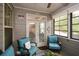 Cozy sunroom with natural light, comfortable seating, and a view of the backyard at 505 Appalachian Woods Dr, Canton, GA 30114