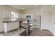Bright kitchen with white cabinets, stainless steel appliances, and a functional island at 7728 Sudbury Cir, Covington, GA 30014