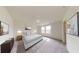 Relaxing primary bedroom with plush carpet, a large window, and elegant decor at 7728 Sudbury Cir, Covington, GA 30014
