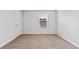 An empty, carpeted bedroom has neutral colors and bright window light at 1645 Fuma Leaf Way, Mcdonough, GA 30253