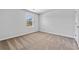 Empty bedroom with carpet, neutral color palette and a bright window at 1645 Fuma Leaf Way, Mcdonough, GA 30253