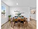Dining room with a table set for six, wood-look floors, bright light from large window at 1645 Fuma Leaf Way, Mcdonough, GA 30253