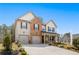 Inviting two-story home with brick and siding, double garage, and professionally landscaped front yard at 1645 Fuma Leaf Way, Mcdonough, GA 30253