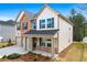 Beautiful two-story home featuring a brick front, double garage, and covered front porch at 1645 Fuma Leaf Way, Mcdonough, GA 30253
