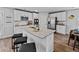 Modern kitchen with white cabinets, an island with seating and stainless steel appliances at 1645 Fuma Leaf Way, Mcdonough, GA 30253