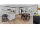 Bright kitchen with white cabinets, granite counters, an island with seating and stainless steel appliances at 1645 Fuma Leaf Way, Mcdonough, GA 30253