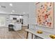 Open-concept kitchen with white cabinetry, stainless steel appliances, and a functional island at 1645 Fuma Leaf Way, Mcdonough, GA 30253