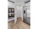 Modern kitchen features a stainless steel refrigerator, double ovens and a walk in pantry at 1645 Fuma Leaf Way, Mcdonough, GA 30253