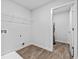 A clean laundry room with wood-look floors and modern appliances at 1645 Fuma Leaf Way, Mcdonough, GA 30253