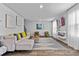 Bright living room with lots of seating, modern decor, wood-look floors and lots of natural light at 1645 Fuma Leaf Way, Mcdonough, GA 30253
