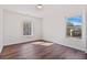 This bedroom features beautiful natural light and wood flooring at 3130 Caney Creek Ln, Cumming, GA 30041