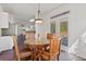 Breakfast nook with a round table, seating for four, a modern light fixture, and access to the backyard at 3130 Caney Creek Ln, Cumming, GA 30041