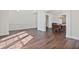 Open-concept dining room with hardwood floors, classic chandelier, and open views to living areas at 3130 Caney Creek Ln, Cumming, GA 30041