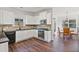 Modern kitchen with white cabinets, granite countertops, stainless steel appliances, and a breakfast nook at 3130 Caney Creek Ln, Cumming, GA 30041