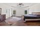 Spacious main bedroom with a tray ceiling, hardwood floors, and access to the bathroom at 3130 Caney Creek Ln, Cumming, GA 30041