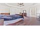 The main bedroom offers natural light, dark hardwood floors, and ensuite bathroom access at 3130 Caney Creek Ln, Cumming, GA 30041