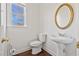 Powder room featuring a pedestal sink, window, white walls and trim, and a gold oval mirror at 3130 Caney Creek Ln, Cumming, GA 30041